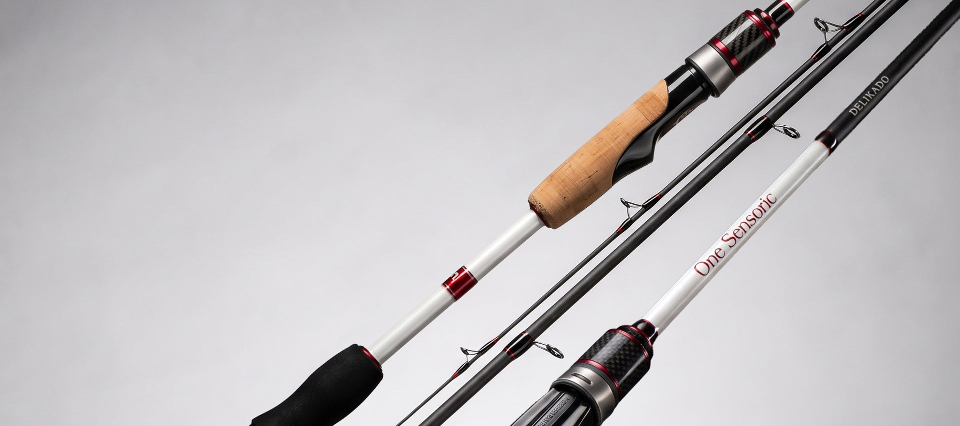 Close-up of a fishing rod with a white shaft, black and red accents, a light wood grip, and a black handle, shown against a light gray background.
