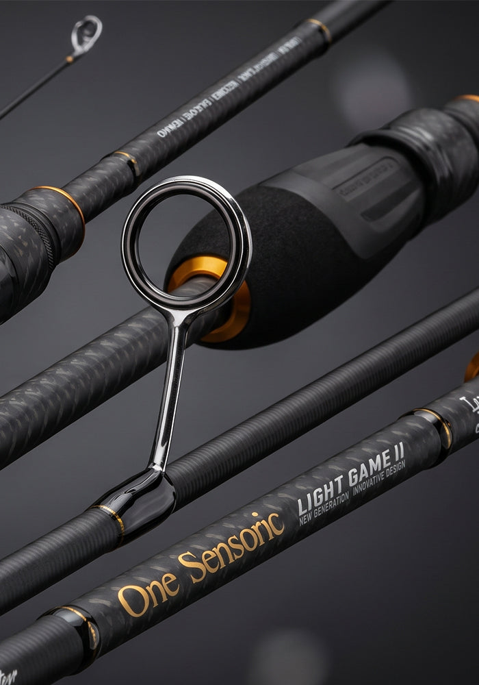 Close-up of a fishing rod set with black carbon-fiber handles, gold accents, and visible One Sensonic branding on a dark studio background.