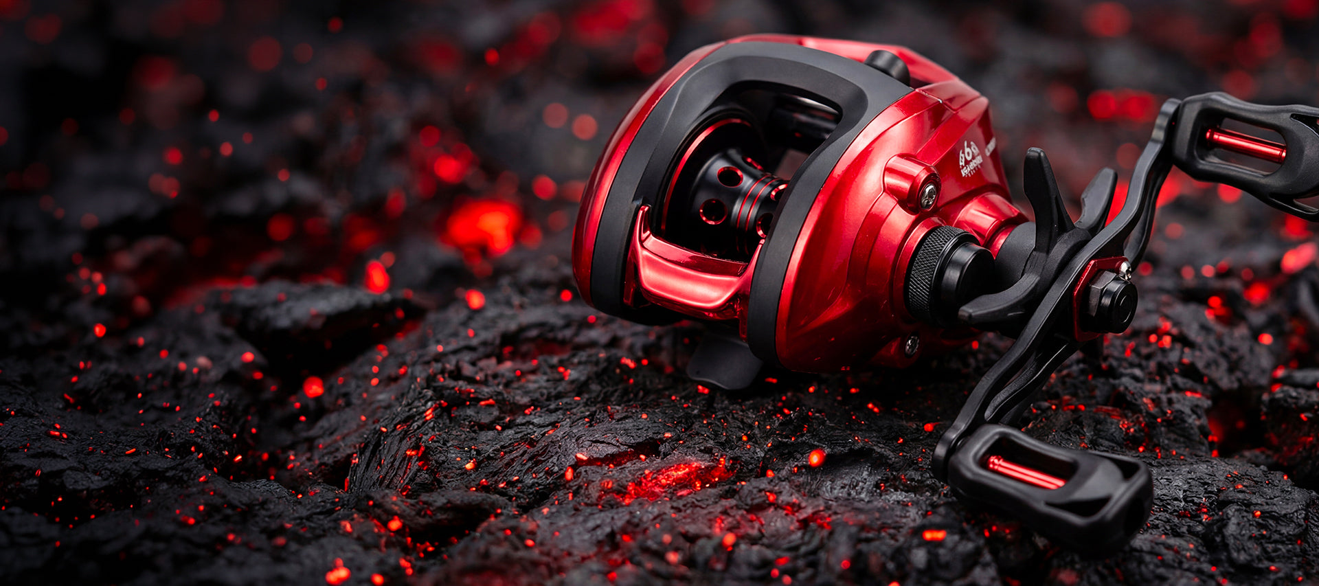 A red and black spinning fishing reel resting on dark textured rocks with glowing red embers in the background.
